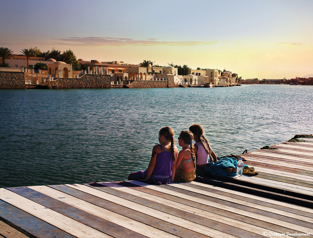 kids seating on the beach of el gouna red sea town